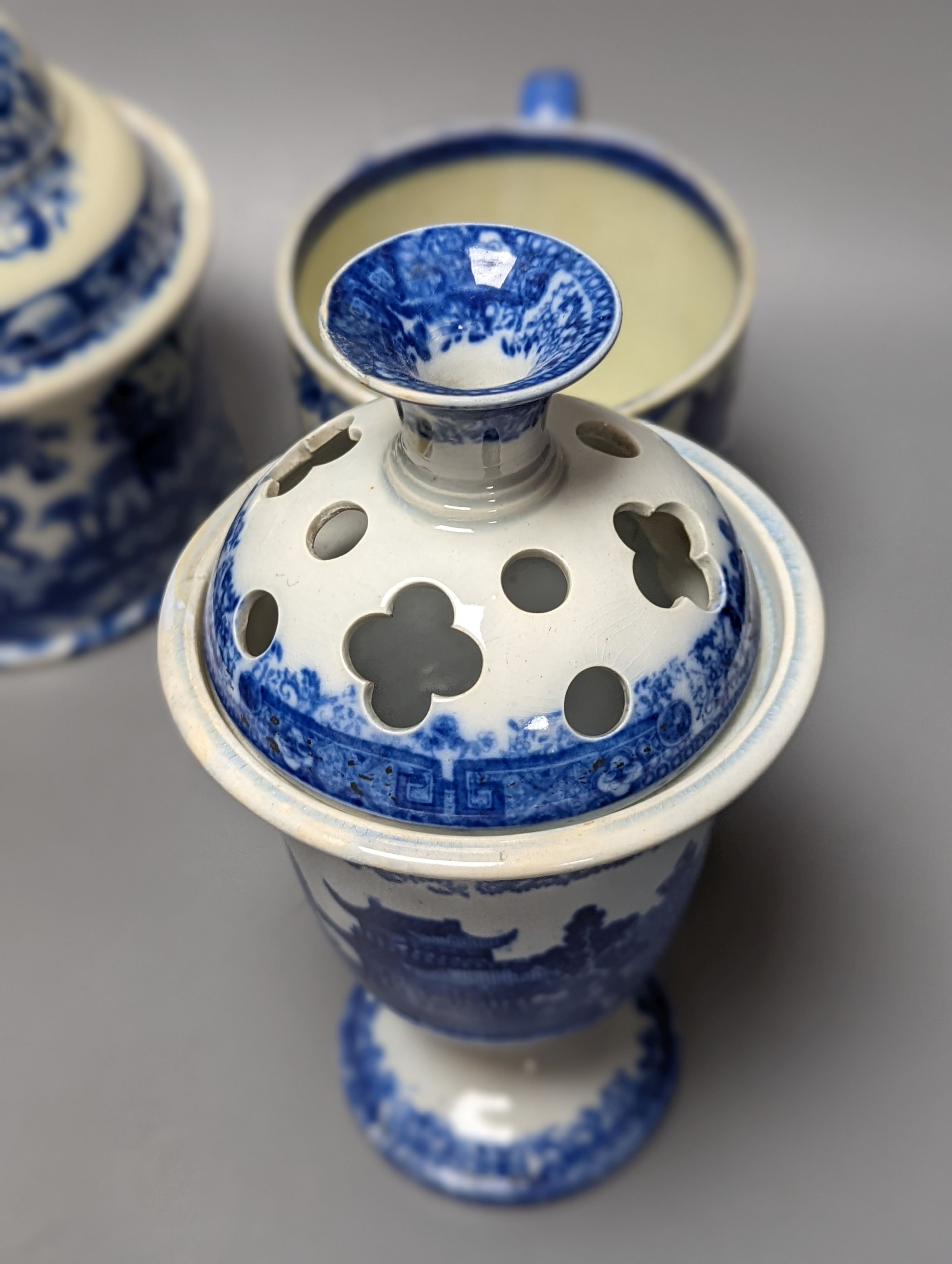 Four items of early 19th century blue and white pearlware pottery, an 18th century Delft blue and white vase and a 19th century toothbrush holder, Delft vase 22 cms high.